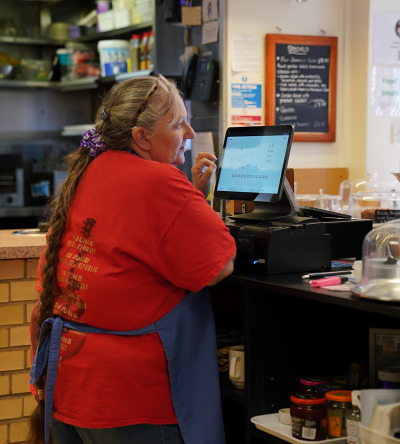 Volunteer serving customers in cafe